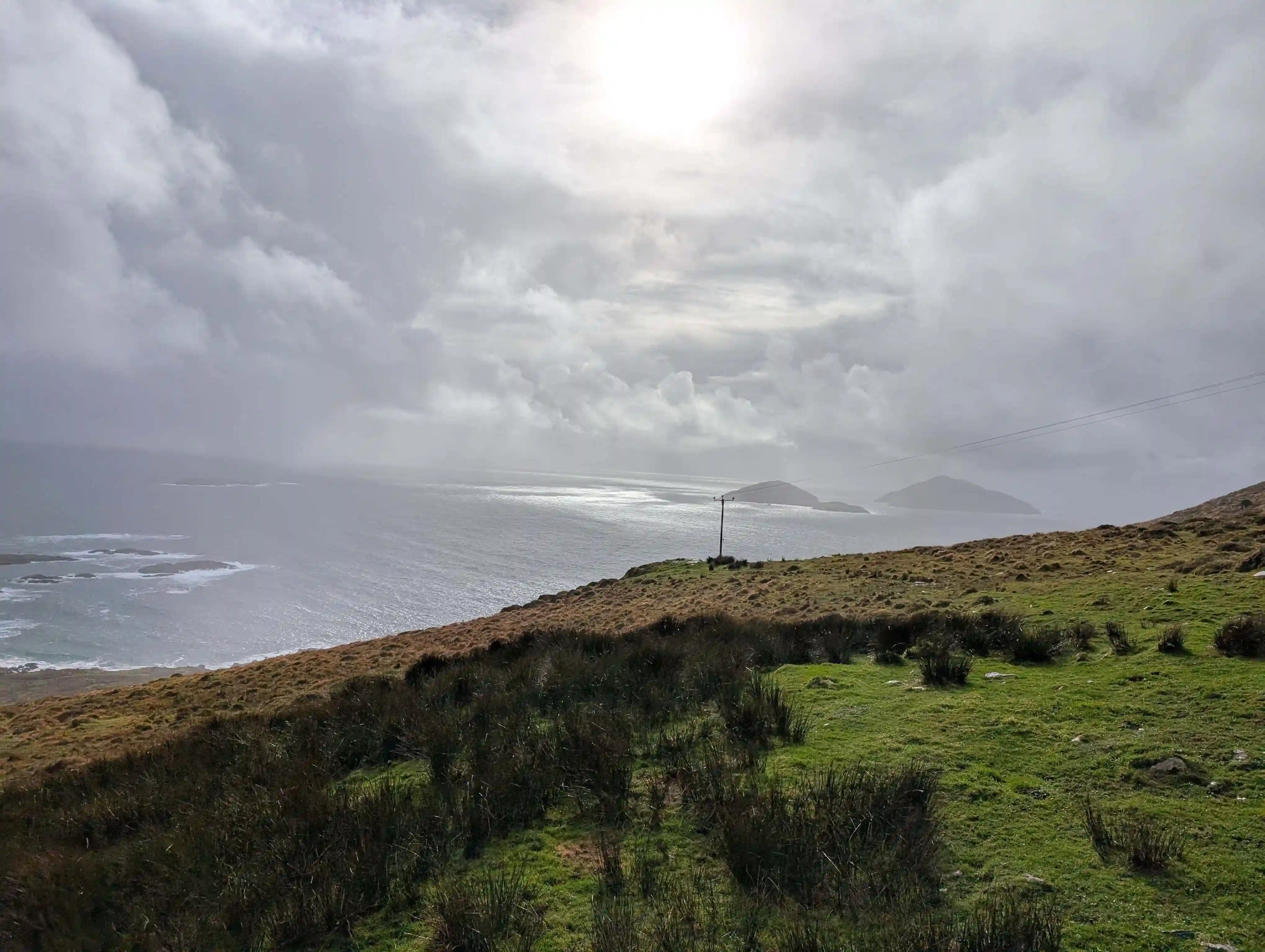 Dramatic coastal vista with green hills meeting the sea